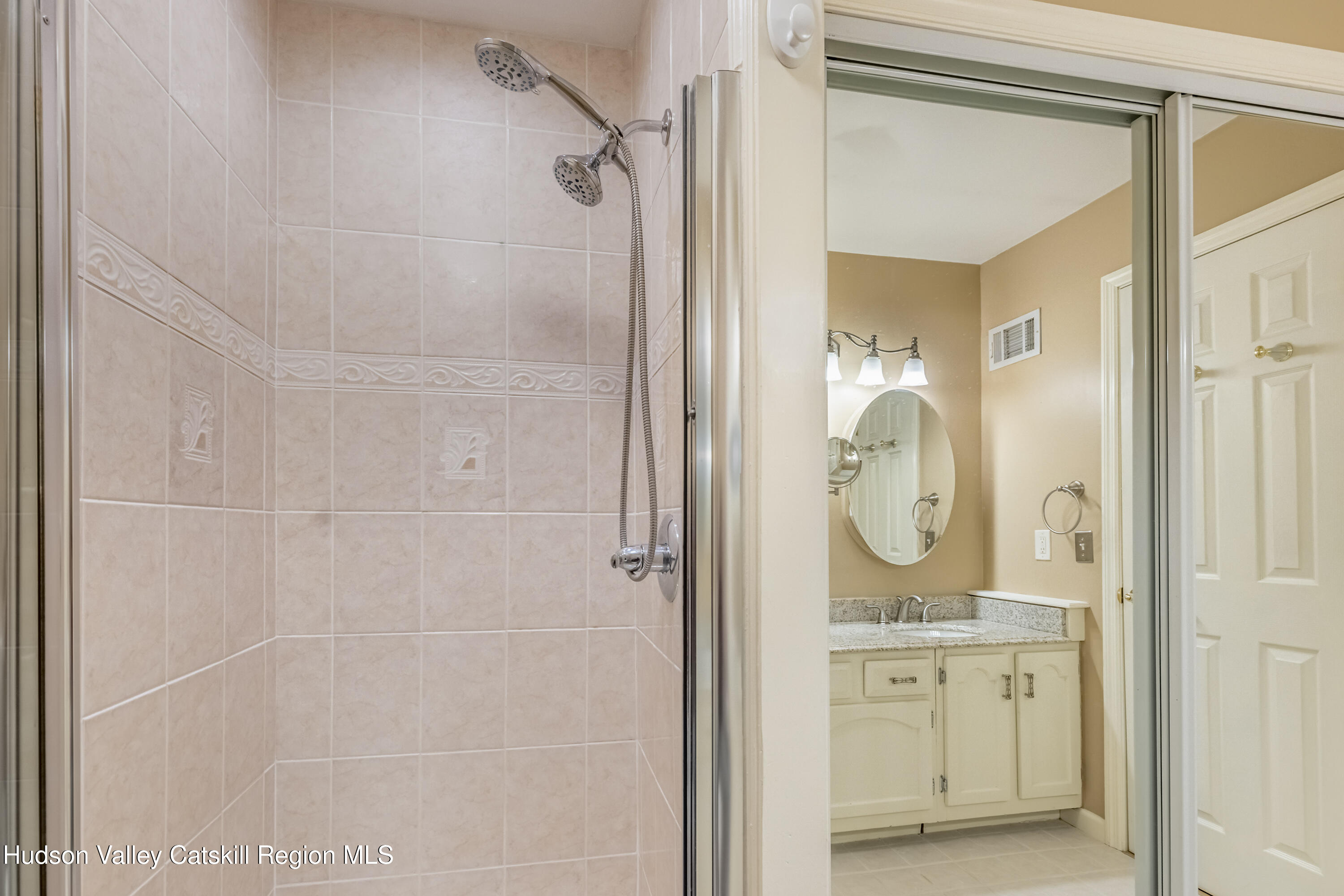 1907 Magnolia Walk Poughkeepsie, NY 12603 - Photo 24 of 36 a bathroom with a granite countertop sink a mirror and shower