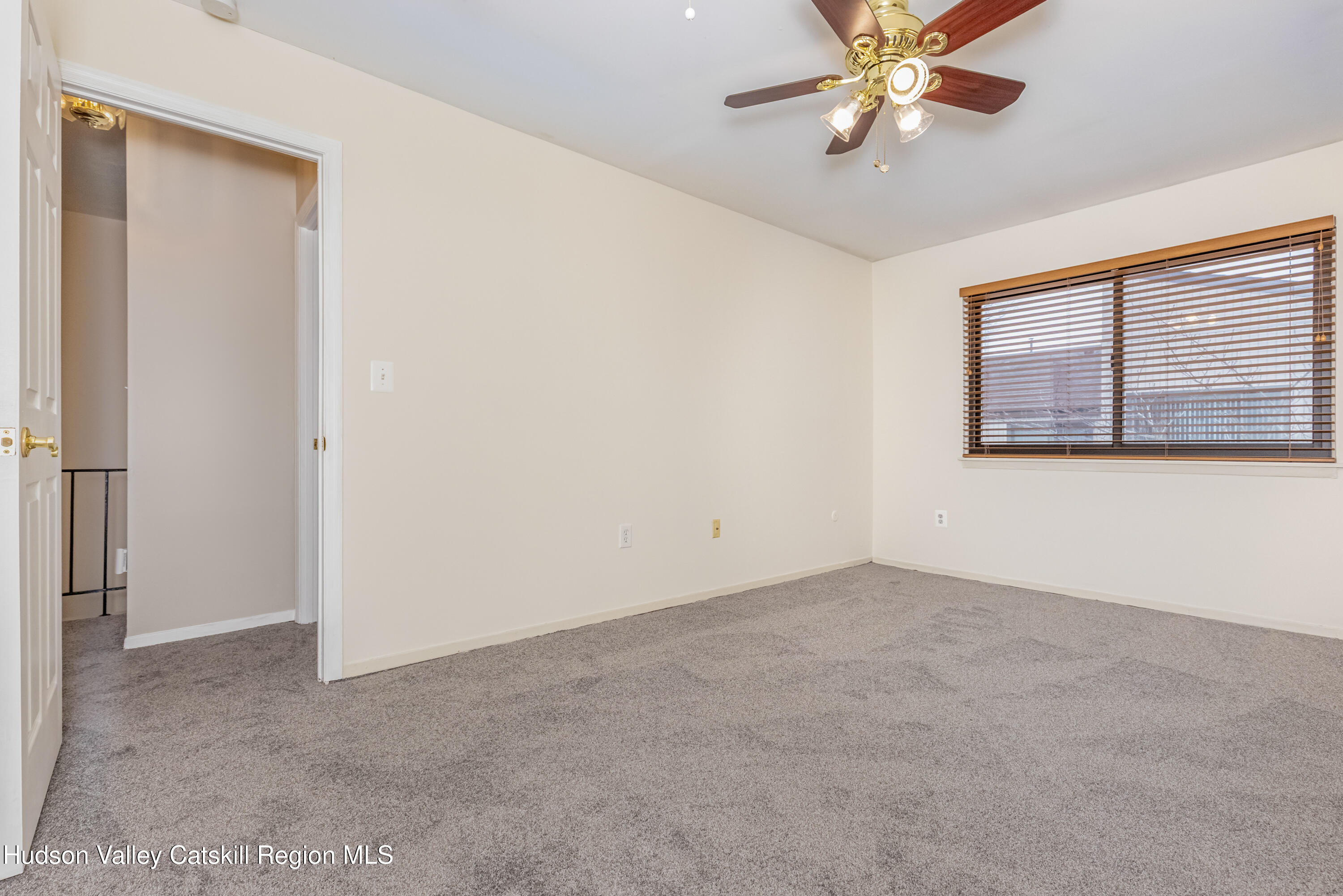 1907 Magnolia Walk Poughkeepsie, NY 12603 - Photo 26 of 36 an empty room with a chandelier fan and windows