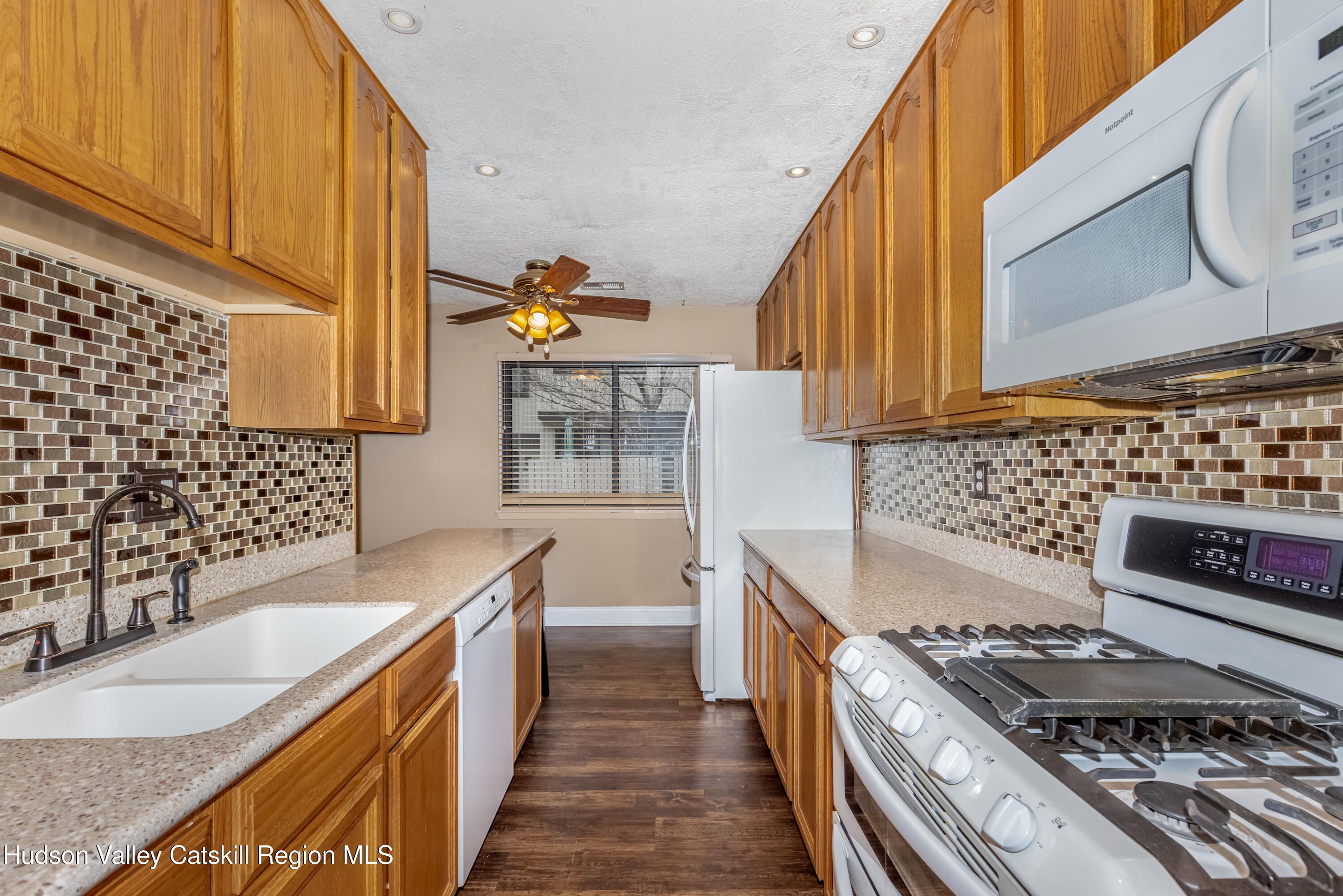 1907 Magnolia Walk Poughkeepsie, NY 12603 - Photo 6 of 36 a kitchen with stainless steel appliances granite countertop a stove a sink and a microwave