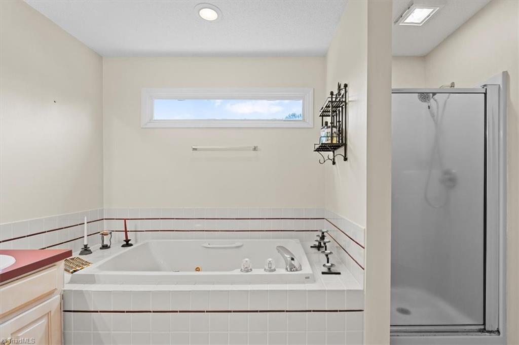 6933 Lawrence Farm Lane Randleman, NC 27317 - Photo 19 of 33 THIS SHOW YOU JETTED TUB AND SHOWER. I LOVE THE TRANSOME WINDOW TO BRING THE LIGHT.