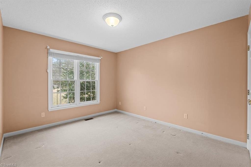 6933 Lawrence Farm Lane Randleman, NC 27317 - Photo 24 of 33 TIRD BEDROOM HAS LOT OF LIGHT COMING IN.