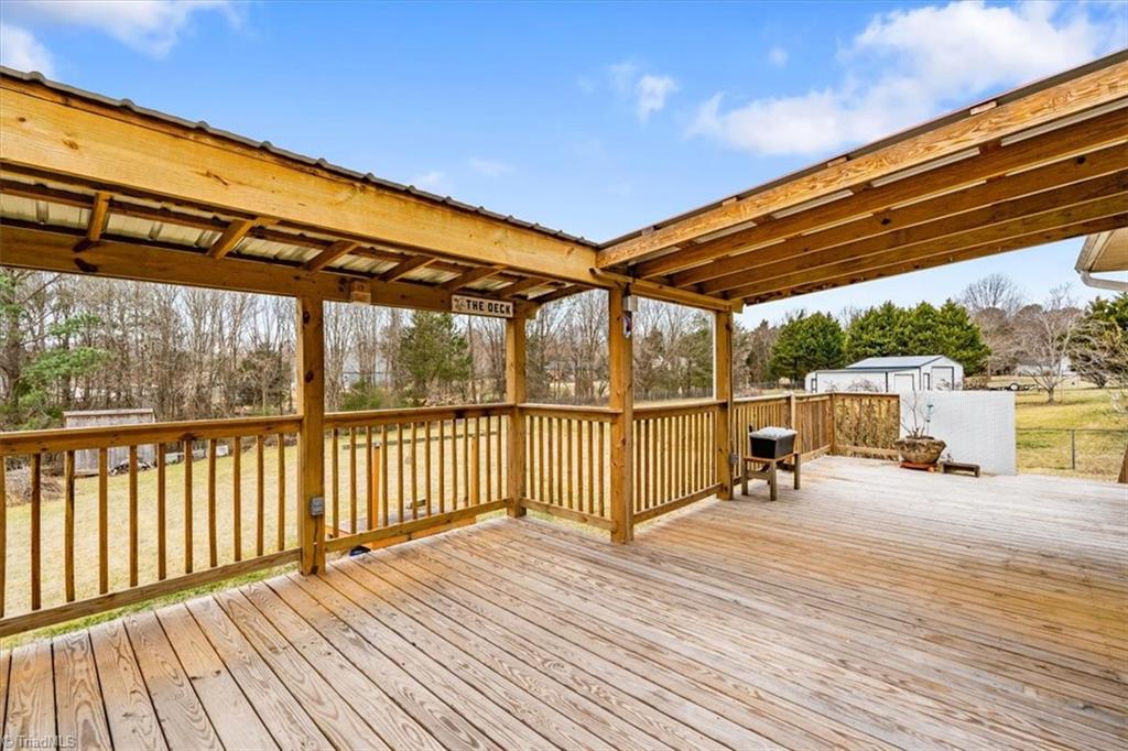 6933 Lawrence Farm Lane Randleman, NC 27317 - Photo 29 of 33 THIS A VIEW FROMO THE OTHER END OF THE DECK.. YOU CAN SEE WHERE THE SELLER PUT UP A ROOF TO GO OVER THE GRILLING AREA