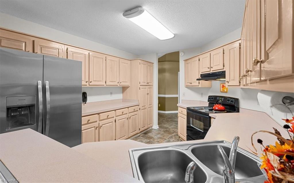 6933 Lawrence Farm Lane Randleman, NC 27317 - Photo 10 of 33 KITCHEN THAT HAS SO MANY CABINETS. THE REFRIGERATOR REMAINS WITH THE PROPERTY