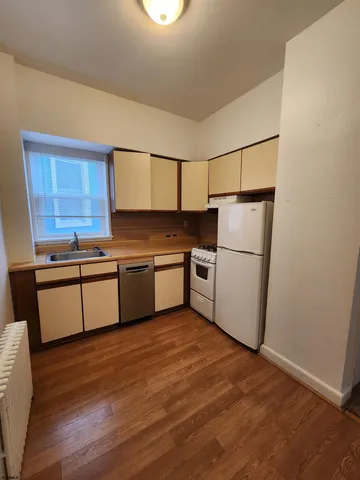 a kitchen with white cabinets and white appliances