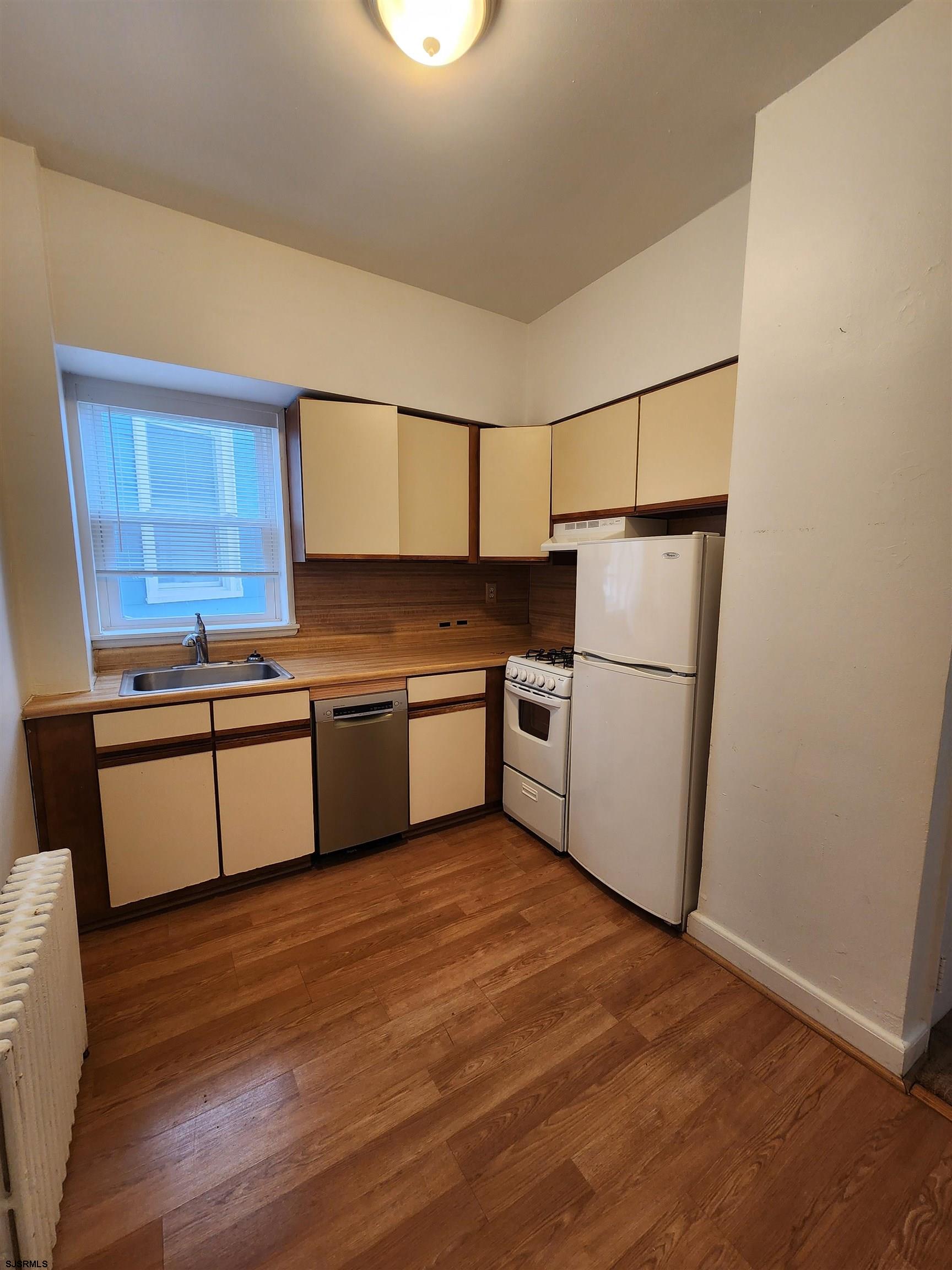 19 South Weymouth Avenue, Unit 2B Ventnor City, NJ 08406 - Photo 2 of 6 a kitchen with white cabinets and white appliances