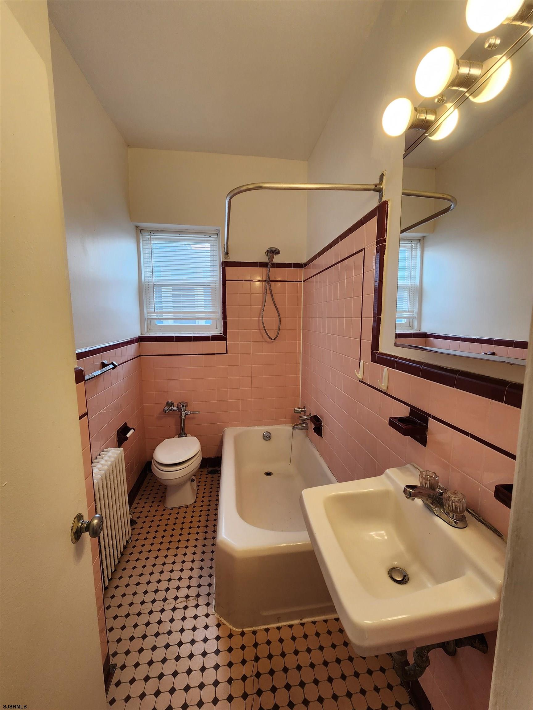 19 South Weymouth Avenue, Unit 2B Ventnor City, NJ 08406 - Photo 3 of 6 a bathroom with a sink a toilet and shower