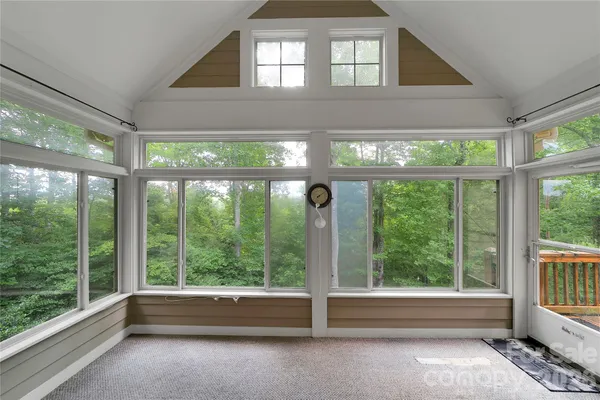 a view of empty room with floor to ceiling windows and floor to ceiling window