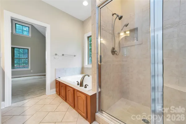 a bathroom with a tub sink and glass door