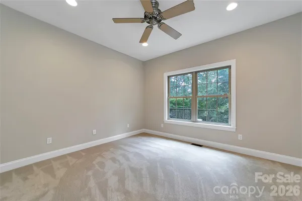 an empty room with a bathroom and a sink
