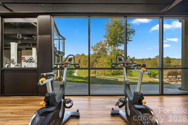 a kitchen with stainless steel appliances dining table chairs and flat screen tv