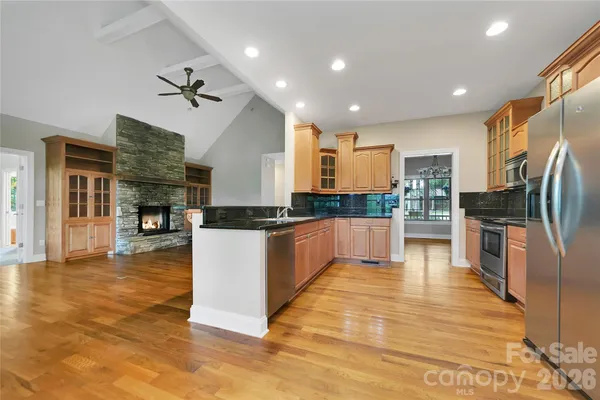 a large kitchen with cabinets and stainless steel appliances