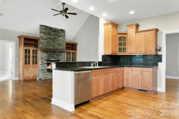a large kitchen with stainless steel appliances granite countertop a stove and a sink