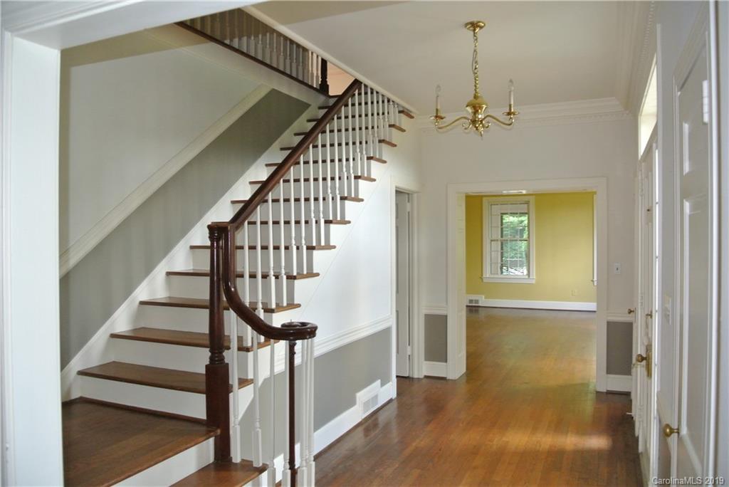 208 Pellyn Wood Road Rutherfordton, NC 28139 - Photo 5 of 18 a view of a hallway with wooden floor and staircase