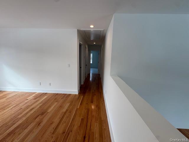 11 Colonels Path Manorville, NY 11949 - Photo 31 of 49 Hallway with light wood finished floors and recessed lighting and open wall over looking the great room