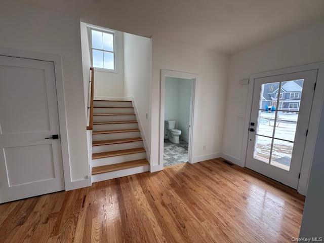 11 Colonels Path Manorville, NY 11949 - Photo 4 of 49 Doorway to outside with stairs and wood finished floors
