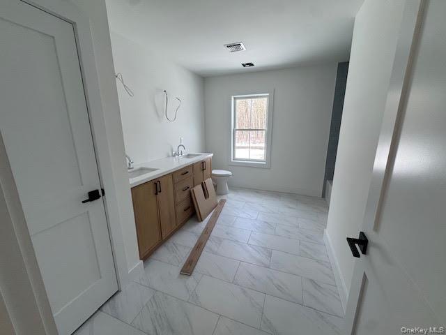 11 Colonels Path Manorville, NY 11949 - Photo 39 of 49 large oversized Bathroom with double vanity and light marble finish flooring with tub