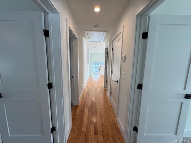 11 Colonels Path Manorville, NY 11949 - Photo 45 of 49 Hall with attic access and light wood-type flooring