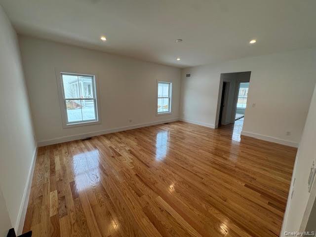 11 Colonels Path Manorville, NY 11949 - Photo 7 of 49 primary bedroom first floor featuring light wood-type flooring and recessed lighting