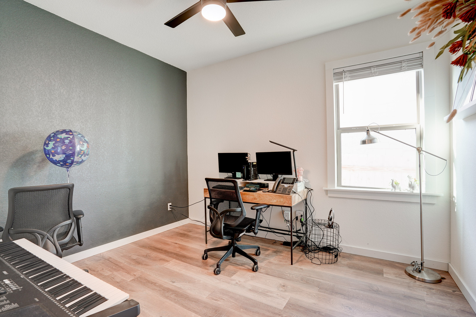 2240 Ringstaff Road Leander, TX 78641 - Photo 19 of 25 Room featuring light wood-finish flooring, a contemporary ceiling fan, and a prominent window with blinds