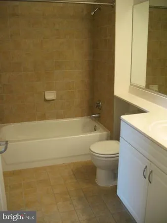 a bathroom with a toilet a sink and bathtub