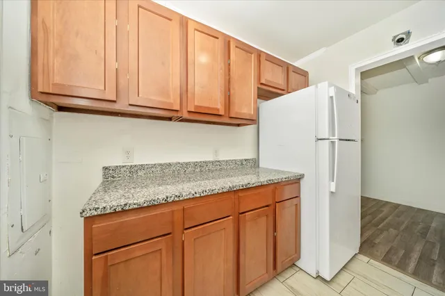 a kitchen with granite countertop cabinets and white appliances