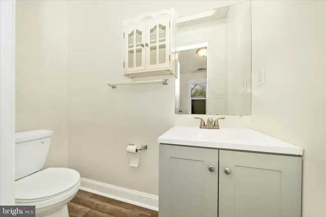 a bathroom with a sink toilet and mirror
