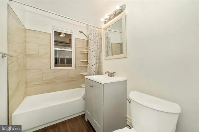 a bathroom with a sink a toilet and bathtub