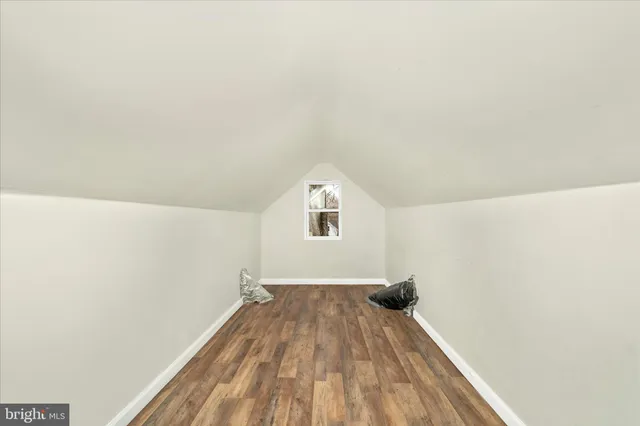 a view of a room with wooden floor staircase and a hallway