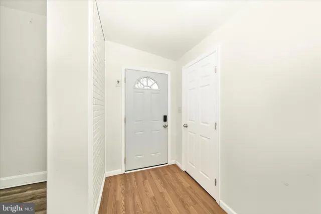 a view of a hallway with wooden floor