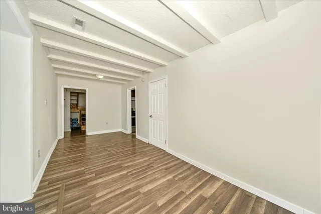a view of a room with wooden floor