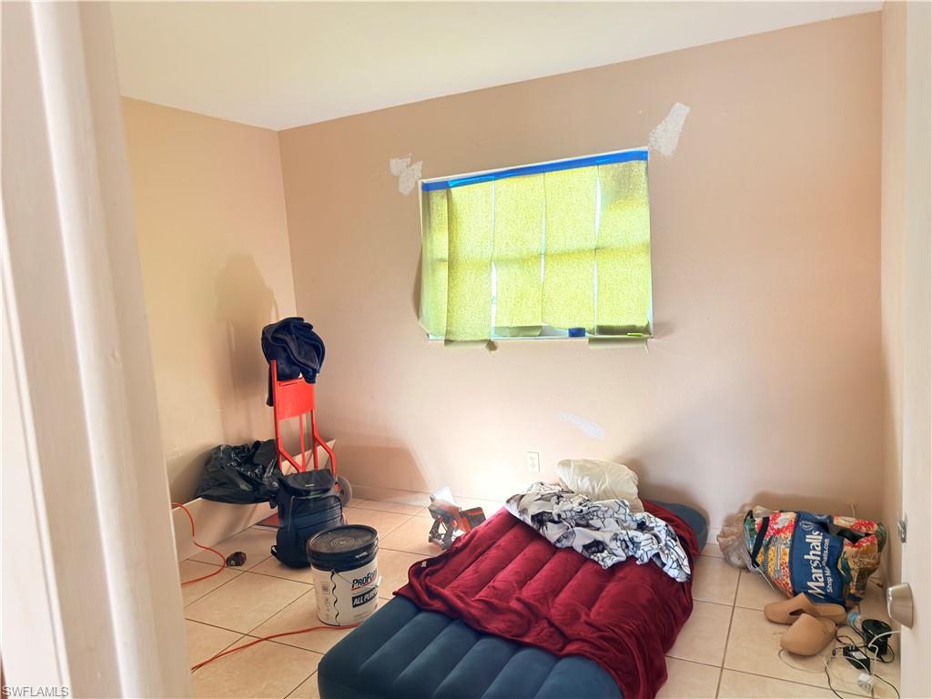 2241 Sunshine Boulevard Naples, FL 34116 - Photo 13 of 35 a bedroom with a bed and a window