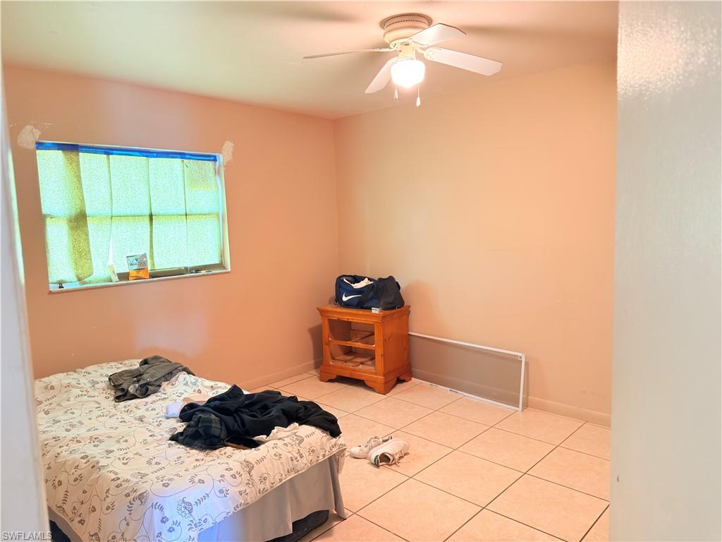 2241 Sunshine Boulevard Naples, FL 34116 - Photo 14 of 35 a bedroom with a bed and a window