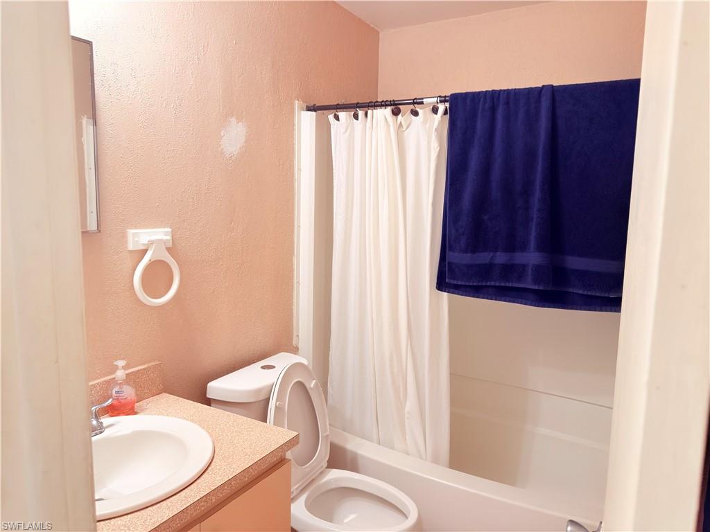 2241 Sunshine Boulevard Naples, FL 34116 - Photo 15 of 35 a bathroom with a sink and a mirror