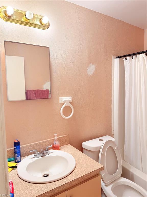 2241 Sunshine Boulevard Naples, FL 34116 - Photo 17 of 35 a bathroom with a toilet sink and mirror