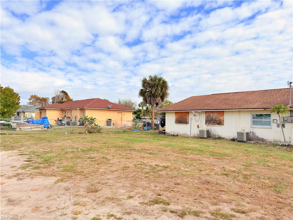2241 Sunshine Boulevard Naples, FL 34116 - Photo 21 of 35 a view of a house with a big yard and a large tree