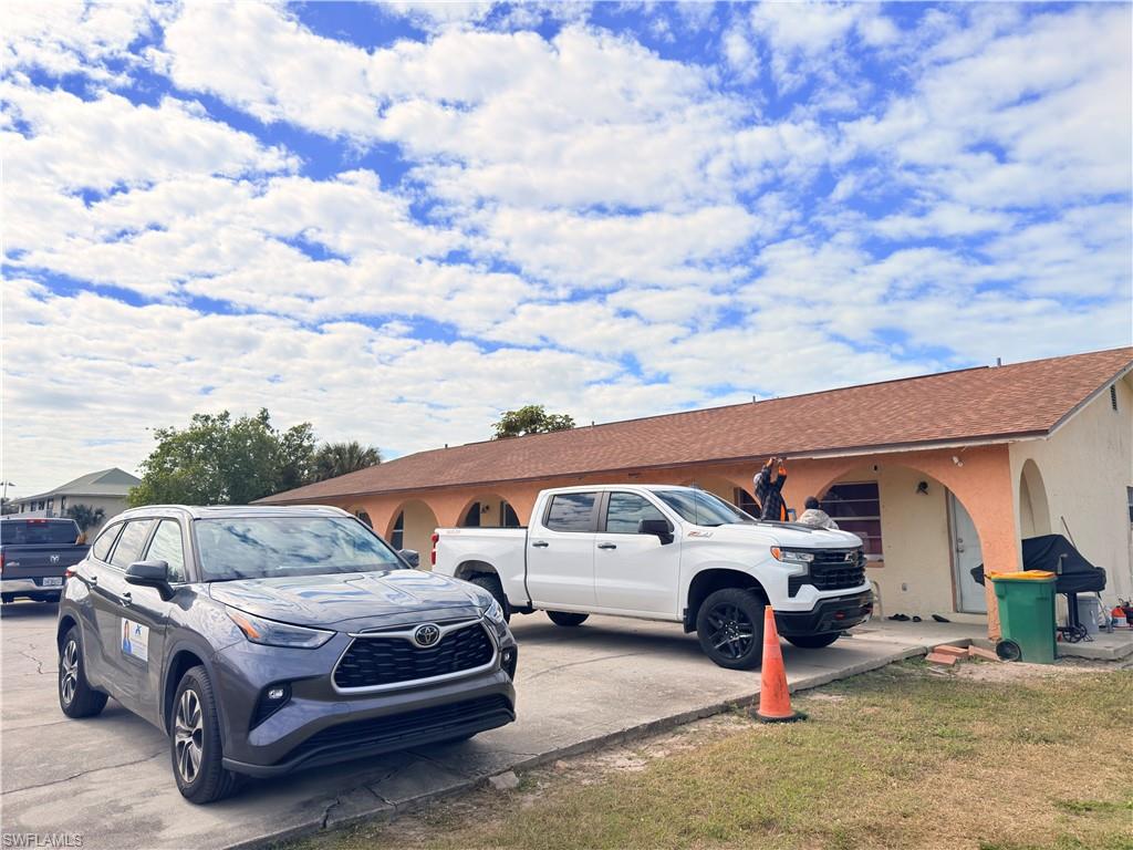2241 Sunshine Boulevard Naples, FL 34116 - Photo 30 of 35 a car parked in front of a white house