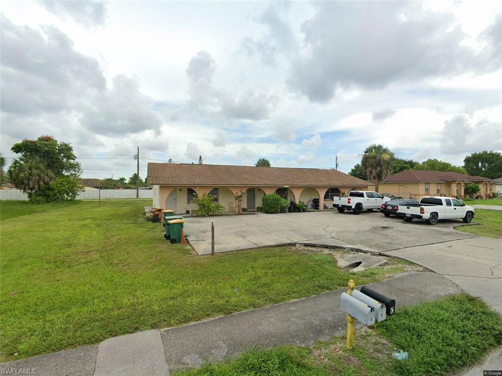 2241 Sunshine Boulevard Naples, FL 34116 - Photo 35 of 35 a car parked in front of a house with a yard