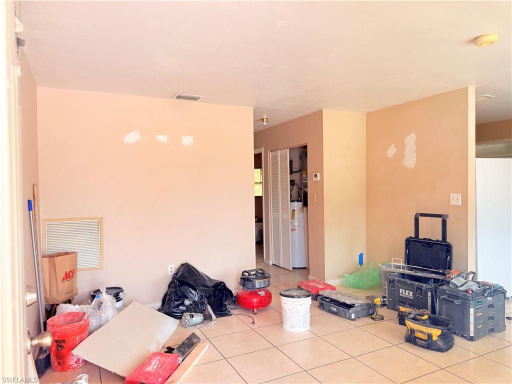2241 Sunshine Boulevard Naples, FL 34116 - Photo 5 of 35 a living room with furniture and a flat screen tv