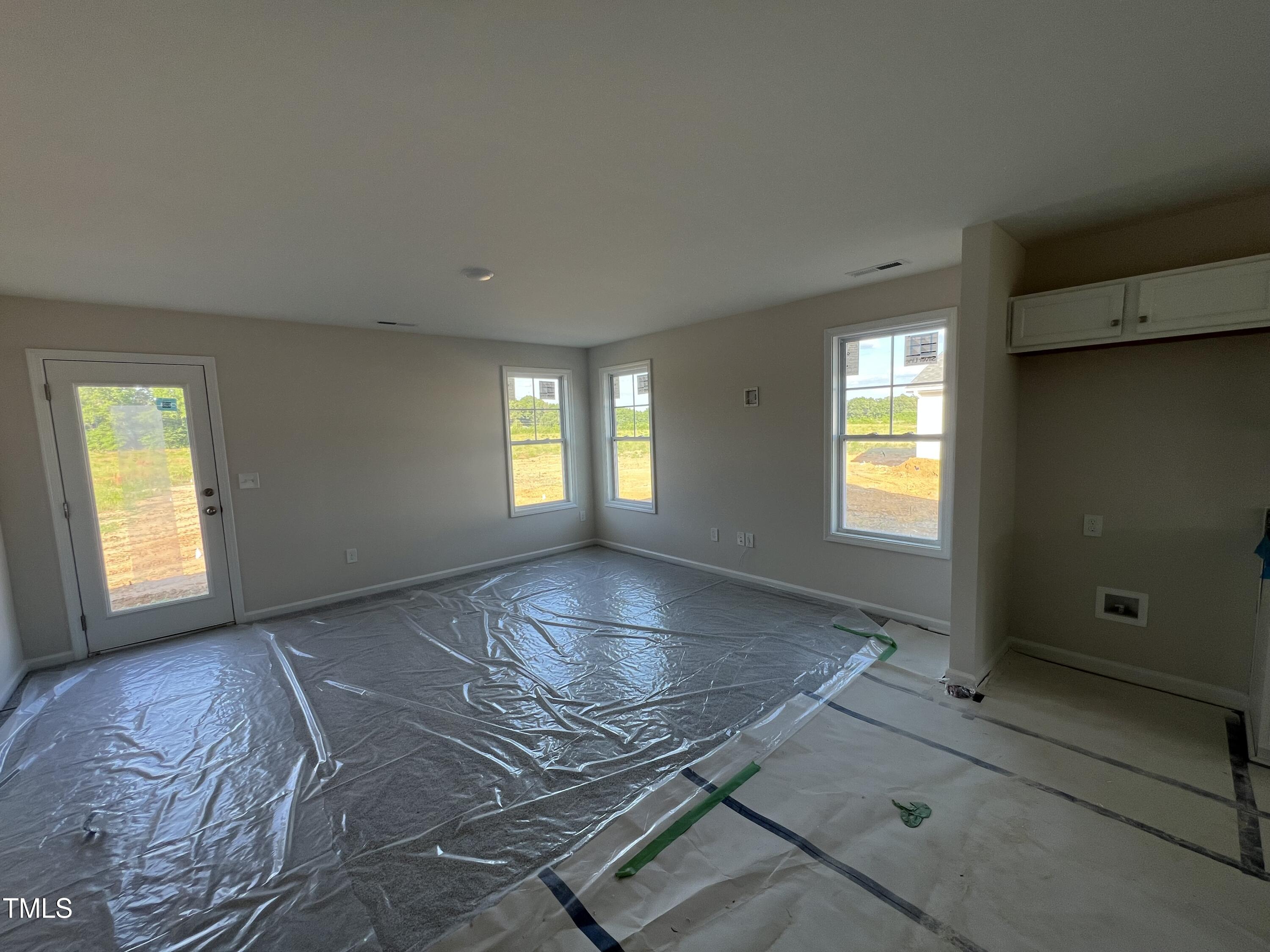 132 Dalton Drive Benson, NC 27504 - Photo 3 of 16 a view of an empty room with a window and wooden floor