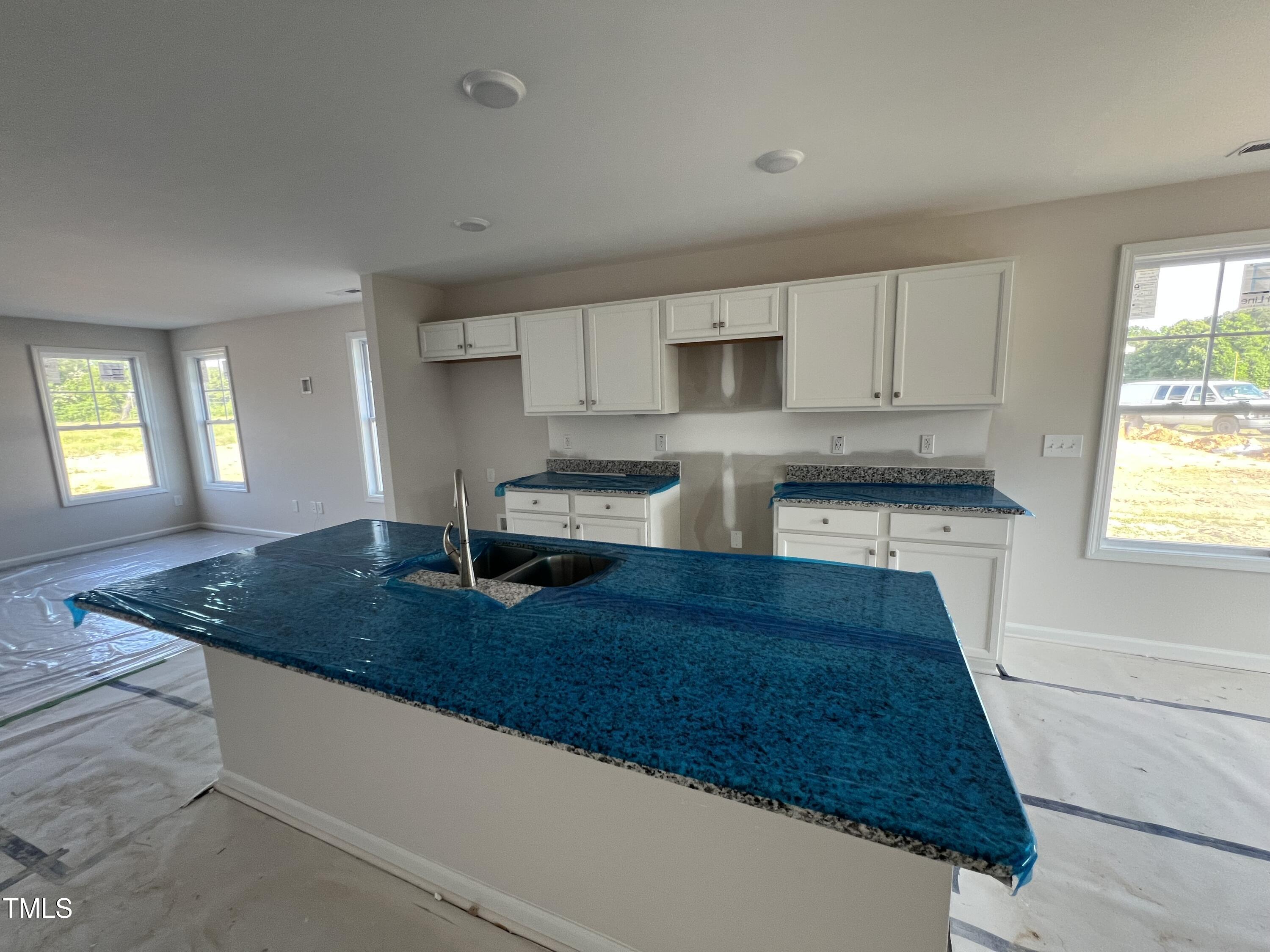 132 Dalton Drive Benson, NC 27504 - Photo 5 of 16 a kitchen with kitchen island granite countertop a sink cabinets and window