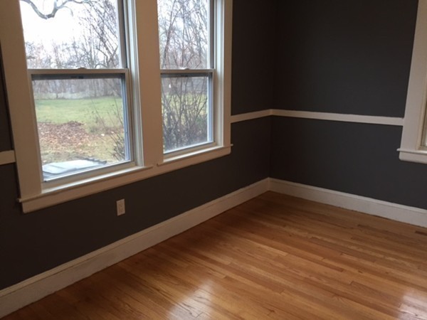 342 Franklin Street Framingham, MA 01702 - Photo 13 of 17 a view of an empty room with wooden floor and a window