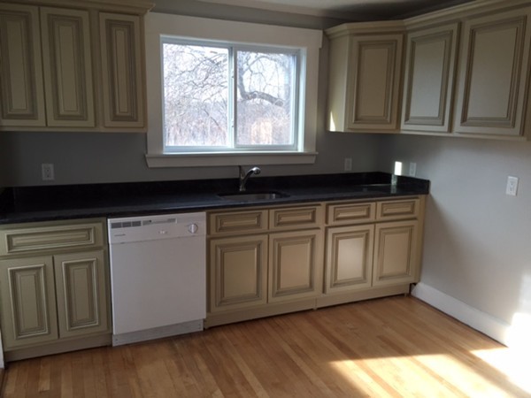 342 Franklin Street Framingham, MA 01702 - Photo 4 of 17 a kitchen with granite countertop wooden cabinets a sink and dishwasher