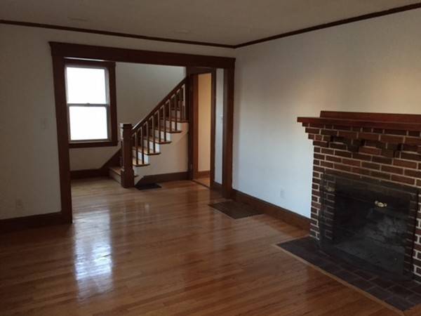 342 Franklin Street Framingham, MA 01702 - Photo 9 of 17 a view of an entryway with wooden floor windows and a fireplace