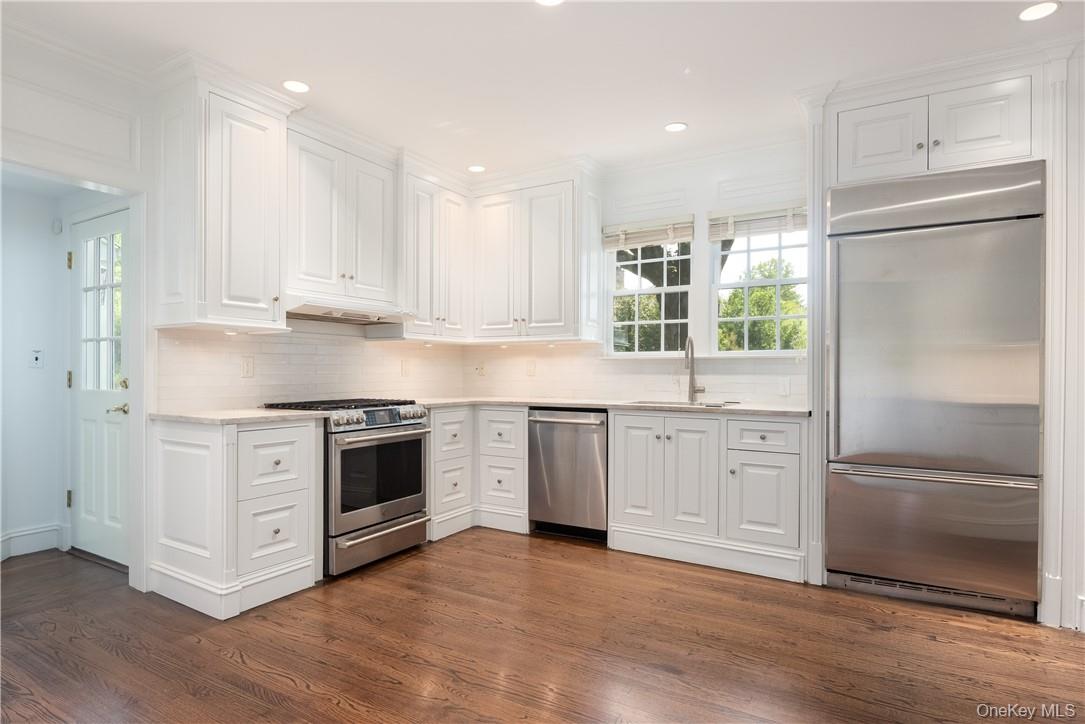 11 Sunset Lane Rye, NY 10580 - Photo 16 of 36 White kitchen features new quartz counter tops, sink and backsplash.