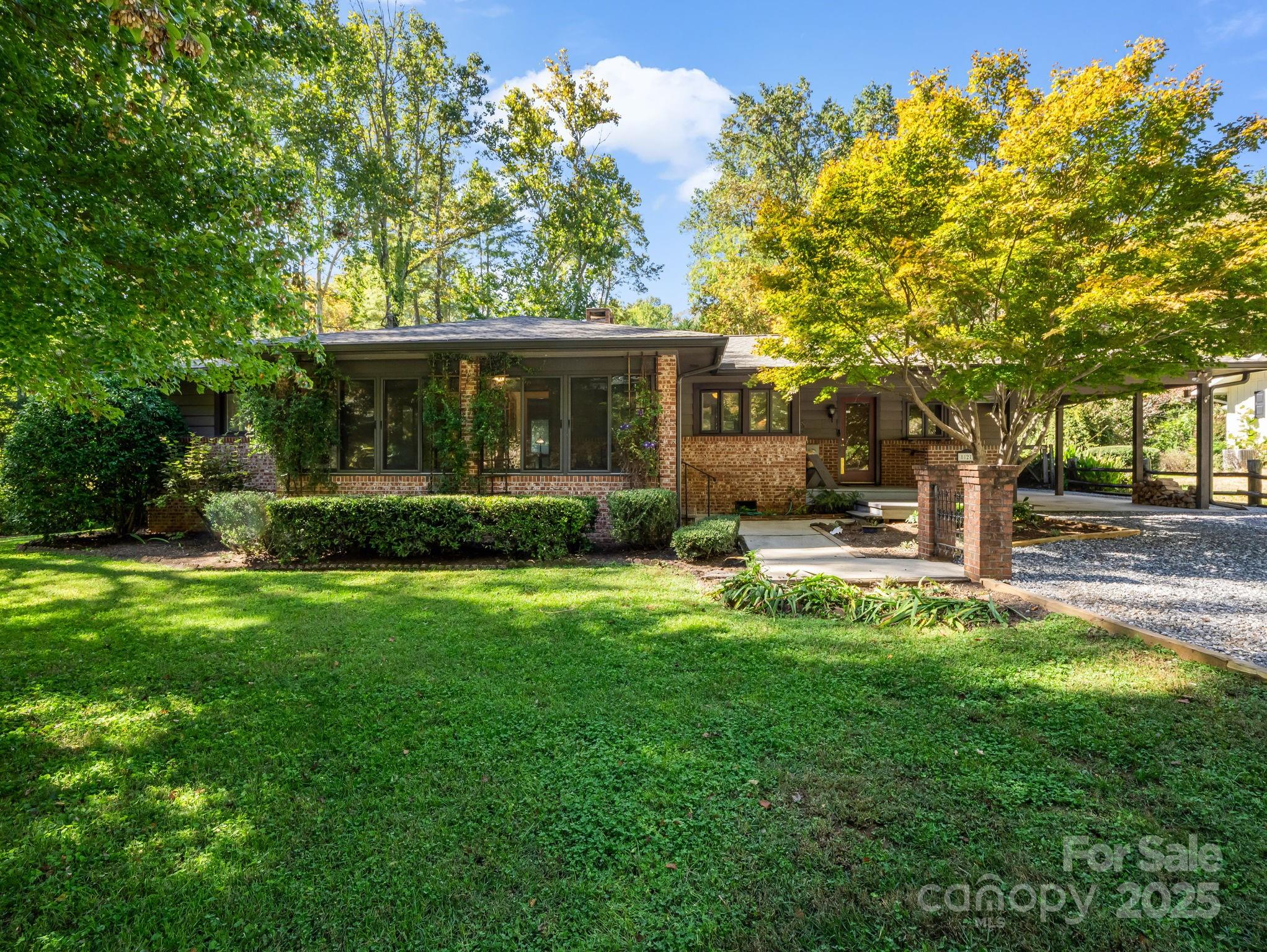 a view of a house with backyard and sitting area