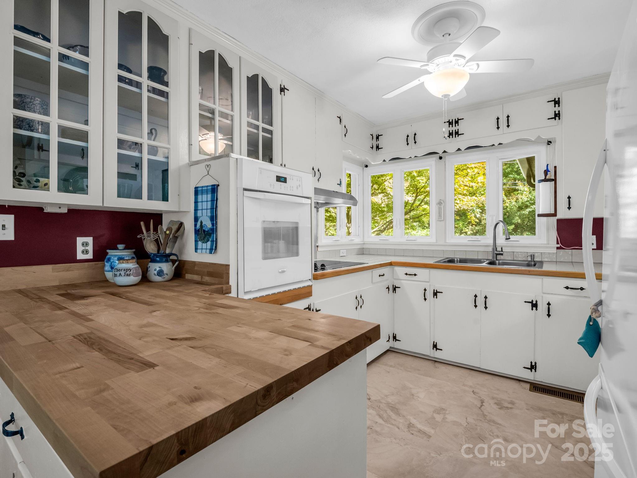 821 Warrior Drive Tryon, NC 28782 - Photo 15 of 44 a kitchen with stainless steel appliances granite countertop a sink window and cabinets