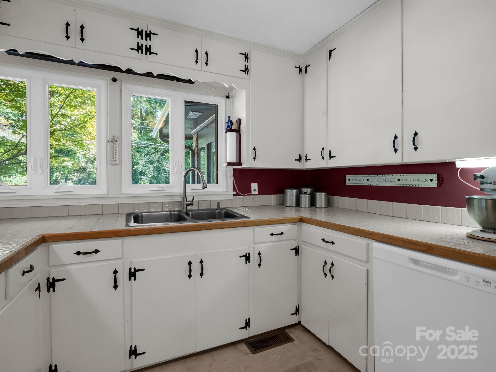 821 Warrior Drive Tryon, NC 28782 - Photo 16 of 44 a kitchen with granite countertop white cabinets white appliances and a sink
