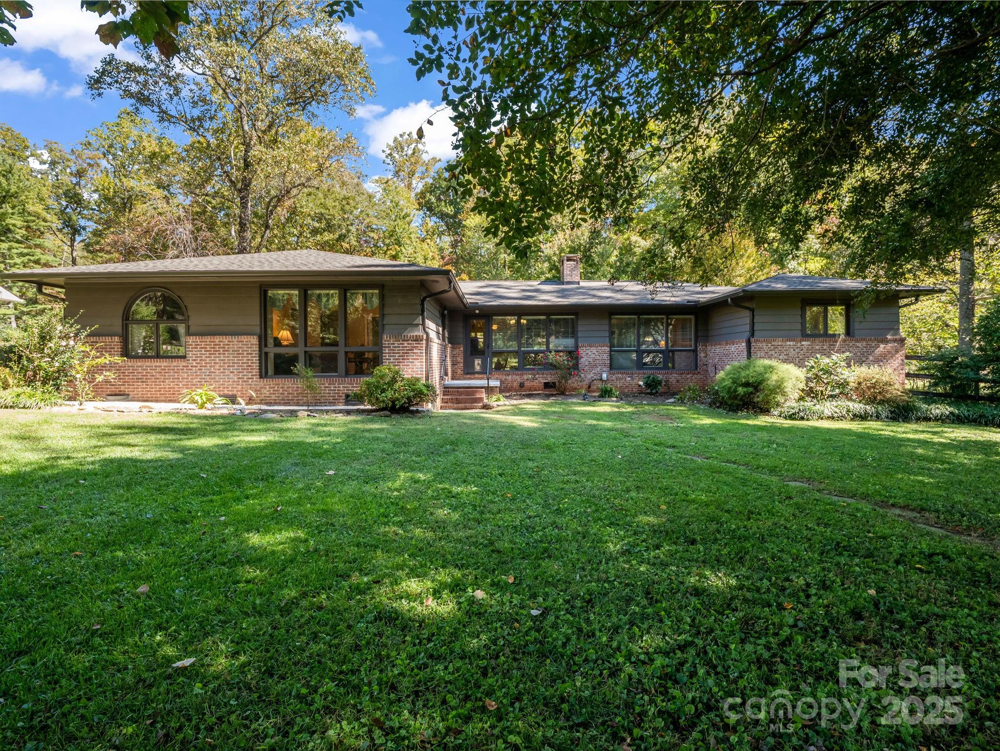 821 Warrior Drive Tryon, NC 28782 - Photo 2 of 44 a front view of house with yard and green space