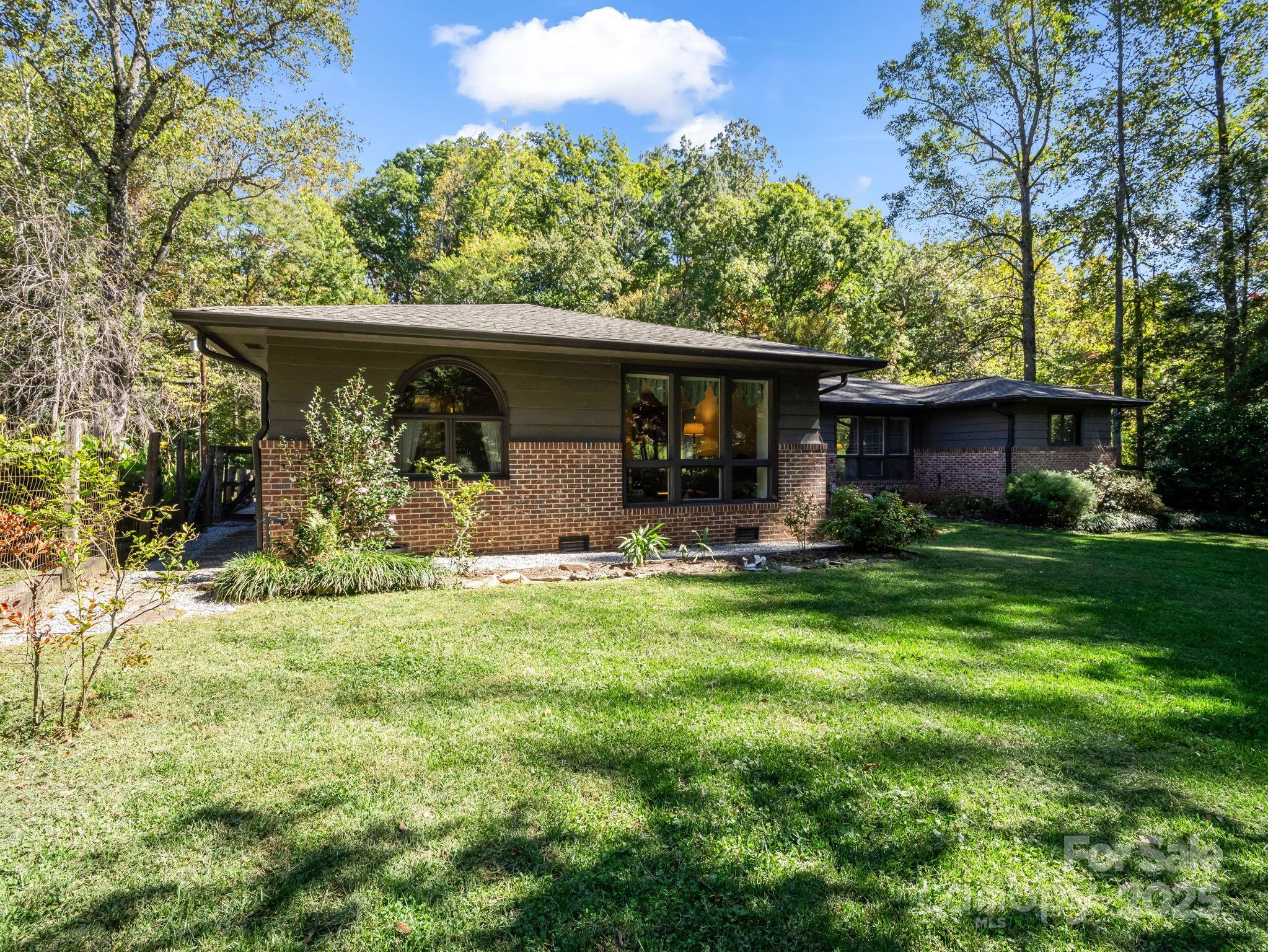 821 Warrior Drive Tryon, NC 28782 - Photo 25 of 44 front view of a house with a yard
