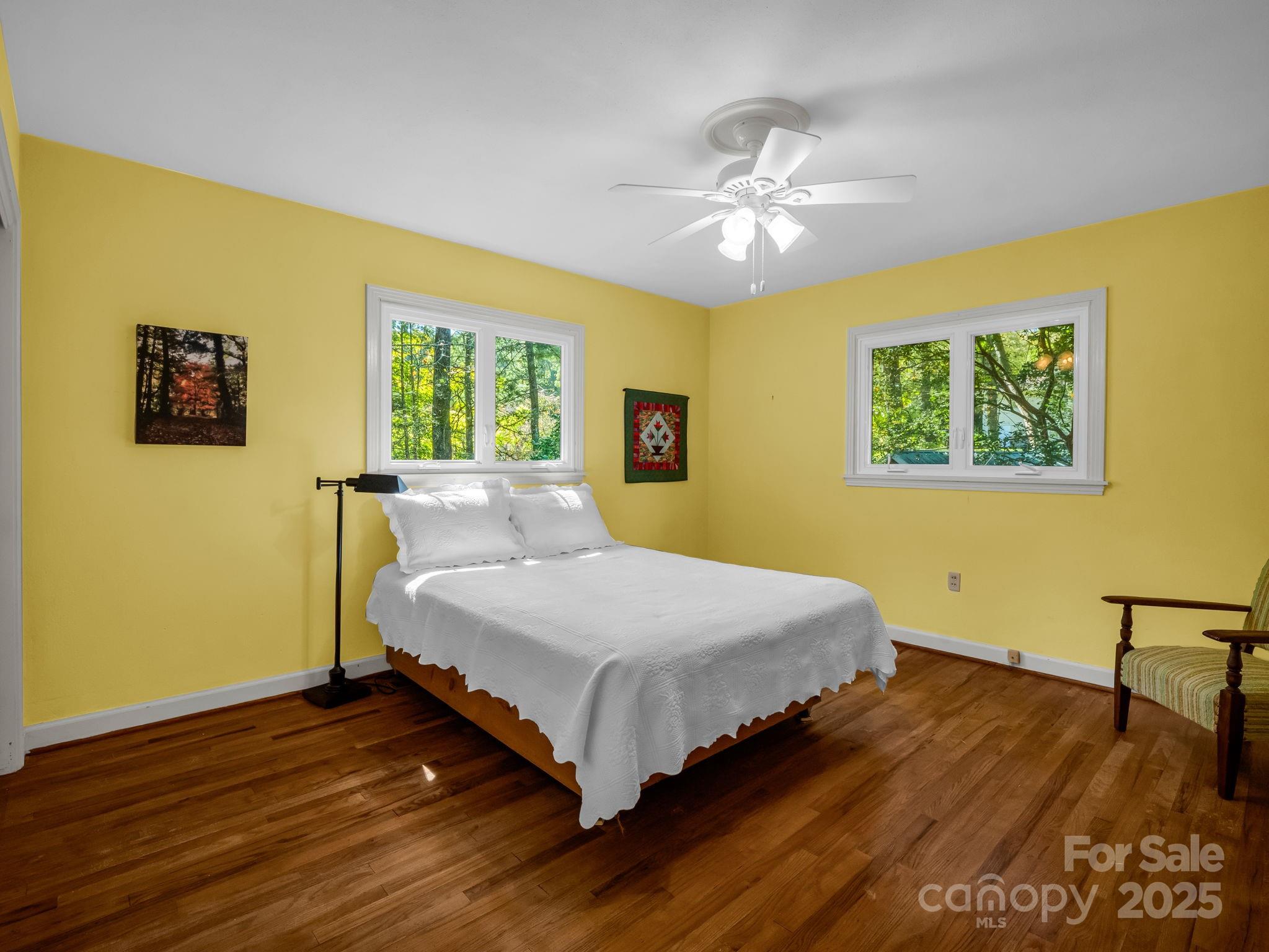 821 Warrior Drive Tryon, NC 28782 - Photo 29 of 44 a bedroom with a bed and wooden floor